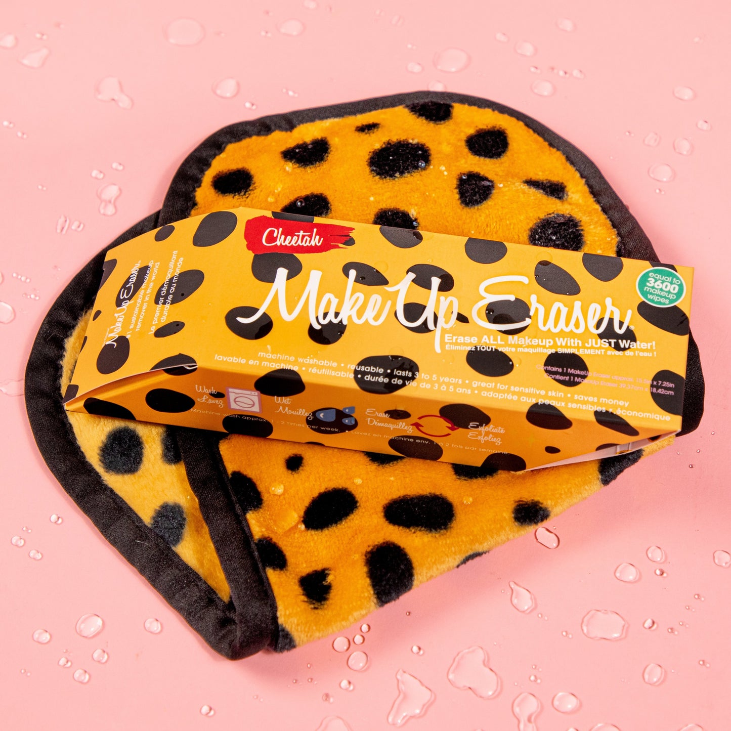 Cheetah Print MakeUp Eraser packaging on top of folded Cheetah Print MakeUp Eraser surrounded by waterdrops.