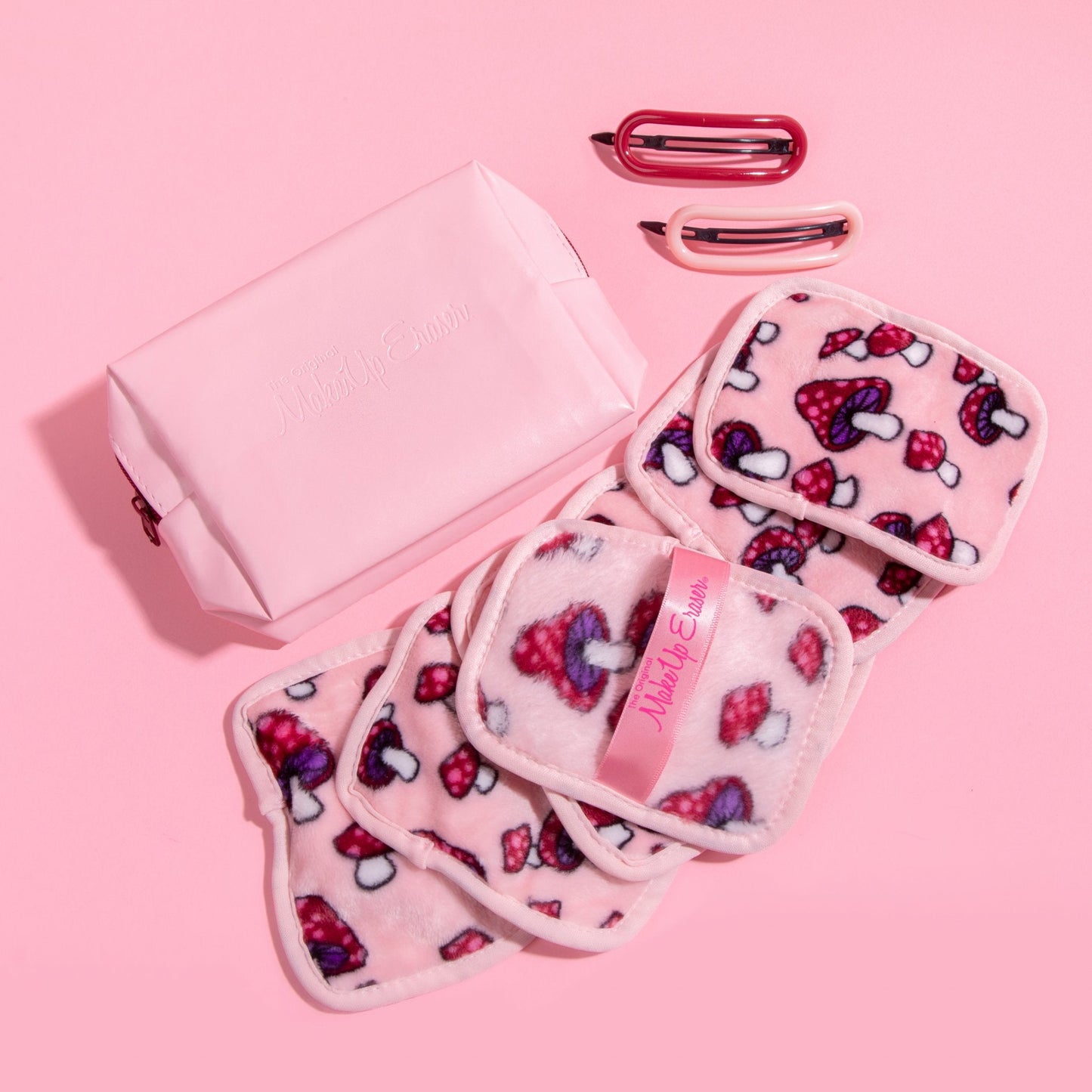 Mushroom 7-Day Set MakeUp Eraser cloths next to reusable makeup bag and hair clips.