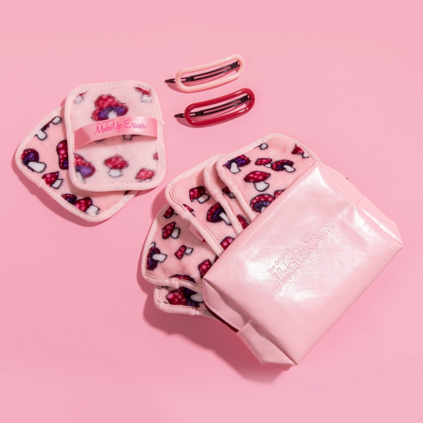 Mushroom 7-Day Set MakeUp Eraser cloths inside of reusable makeup bag next to hair clips.