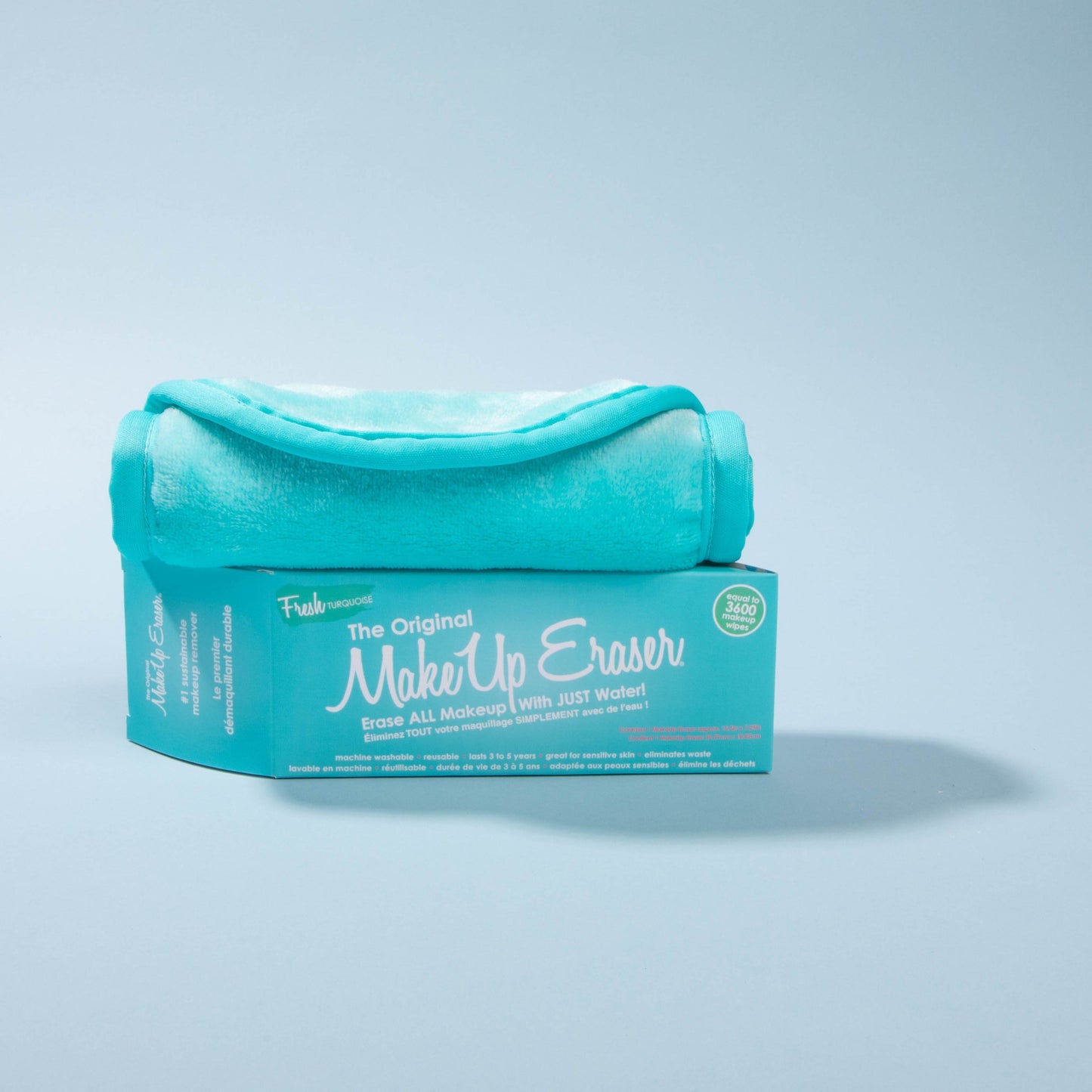 Rolled up Fresh Turquoise MakeUp Eraser on top of packaging.