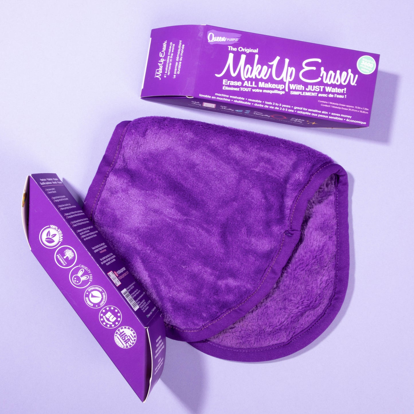Folded Queen Purple MakeUp Eraser cloth next to two Queen Purple packages.