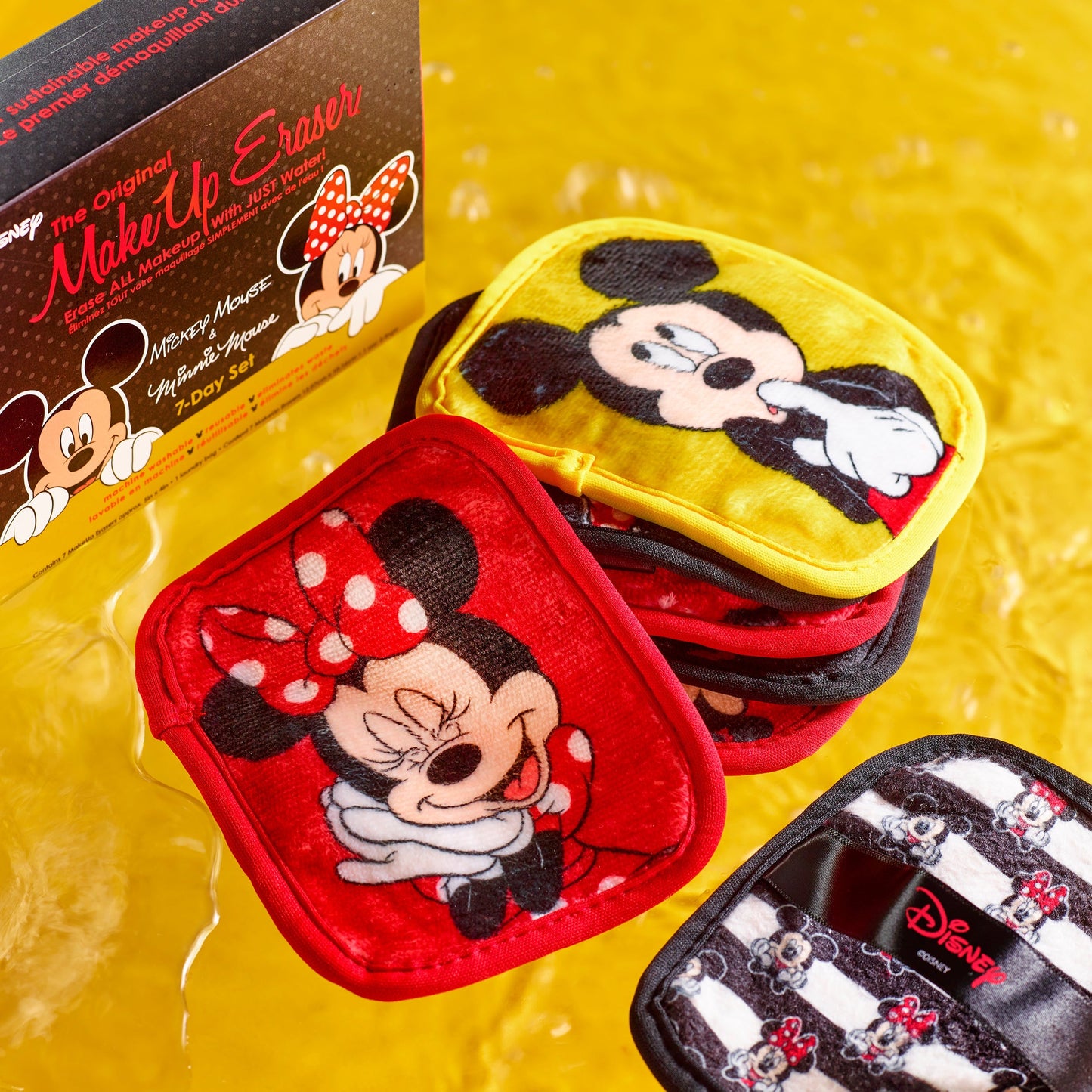 Mickey & Minnie 7-Day Set MakeUp Eraser cloths next to packaging surrounded by water. 