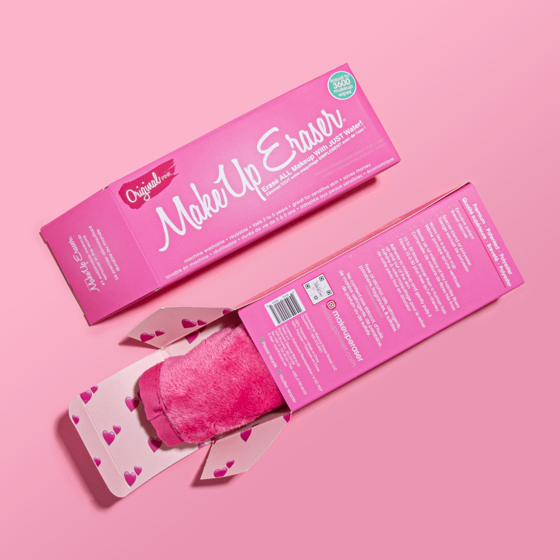 Front of Original Pink MakeUp Eraser packaging next to the back of Original Pink MakeUp Eraser packaging. The back of the packaging is open with a rolled-up Original Pink MakeUp Eraser peeking out.