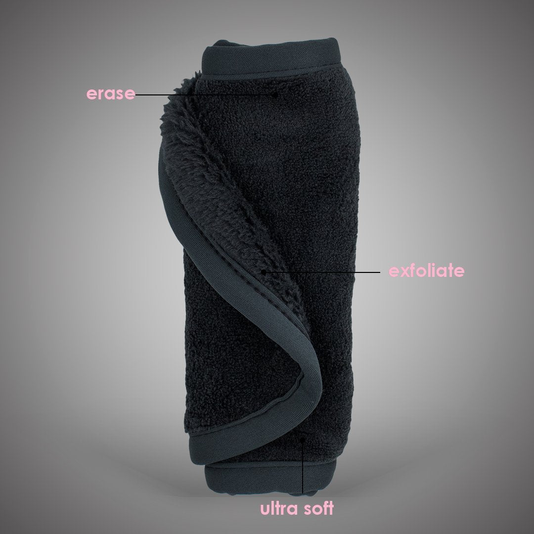 Rolled up Chic Black MakeUp Eraser with both sides exposed. The short fiber side is labeled as erase, and the long fiber side is labeled as exfoliate.