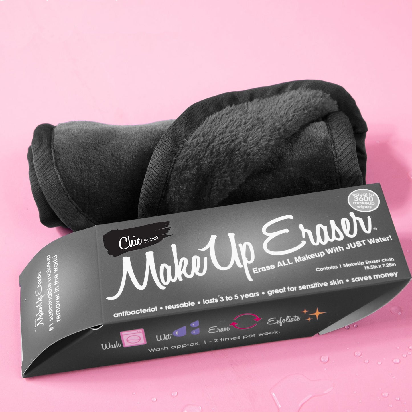 Rolled up Chic Black MakeUp Eraser next to packaging surrounded by waterdrops.
