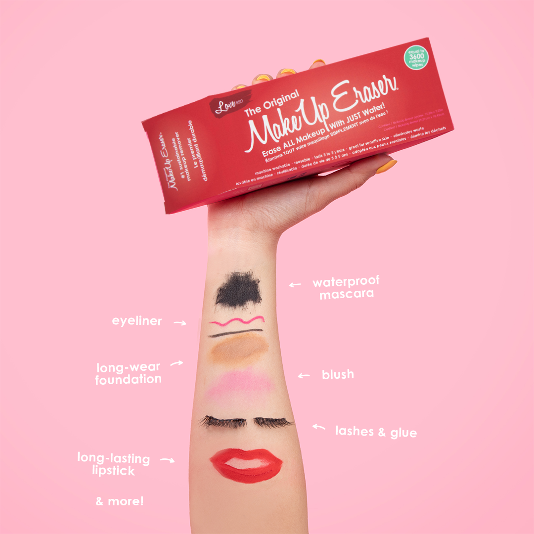 Hand holding Love Red MakeUp Eraser packaging. There is writing on the arm that calls out the various makeup that MakeUp Eraser can remove.