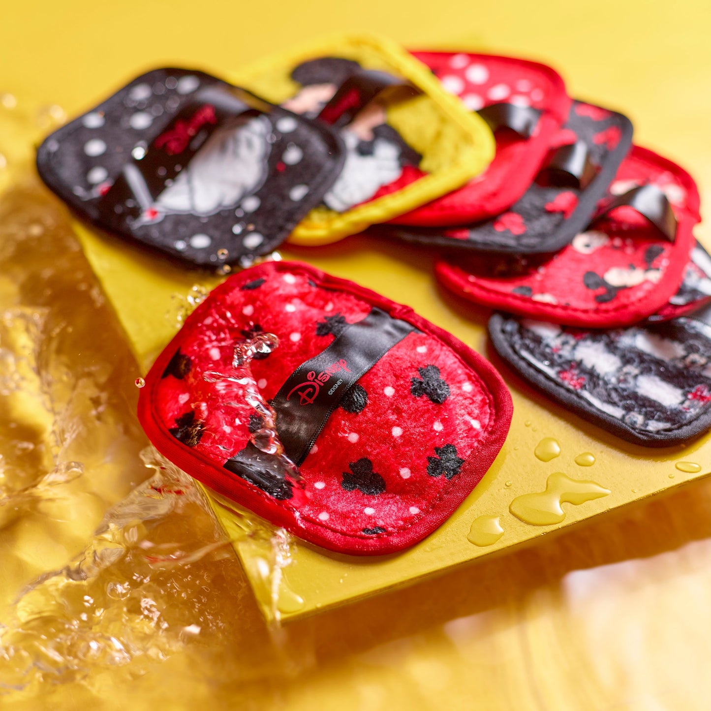 Mickey & Minnie 7-Day Set MakeUp Eraser cloths surrounded by water.